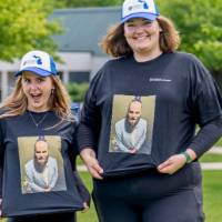 Two players show off their matching shirts and hats